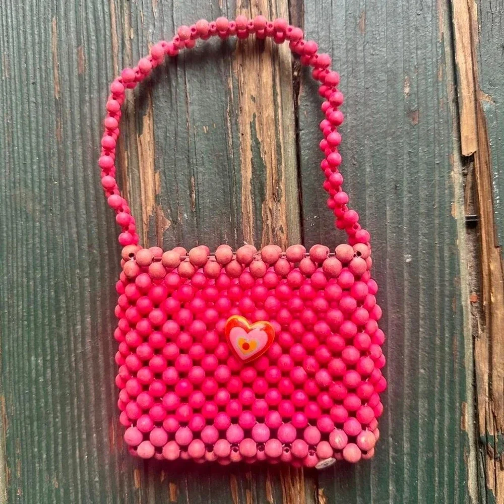 Pink and red beaded‎ bag with heart charm